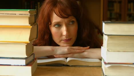 worried student looking at a pile of books