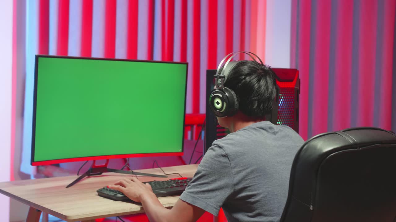 Gamer Playing Video Game With A Mock Up Green Screen