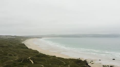 sandy godrevy beach with rocky sections along godrevy coastline in cornwall, united kingdom