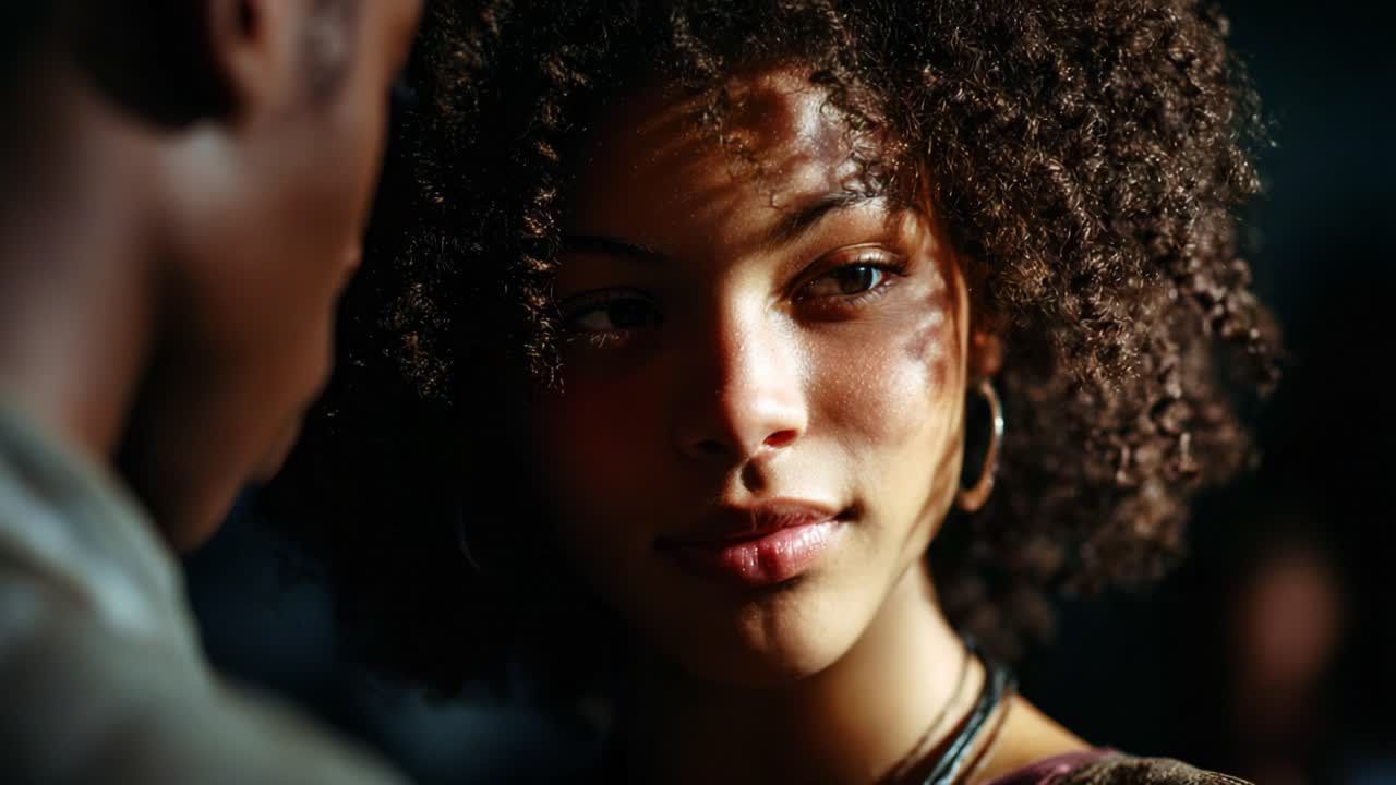A Captivating Moment: A Close-Up Interaction Between Two Individuals Highlighted by Soft Light and Deep Shadows, Emphasizing Expressions and Emotional Connection in a Unique Setting