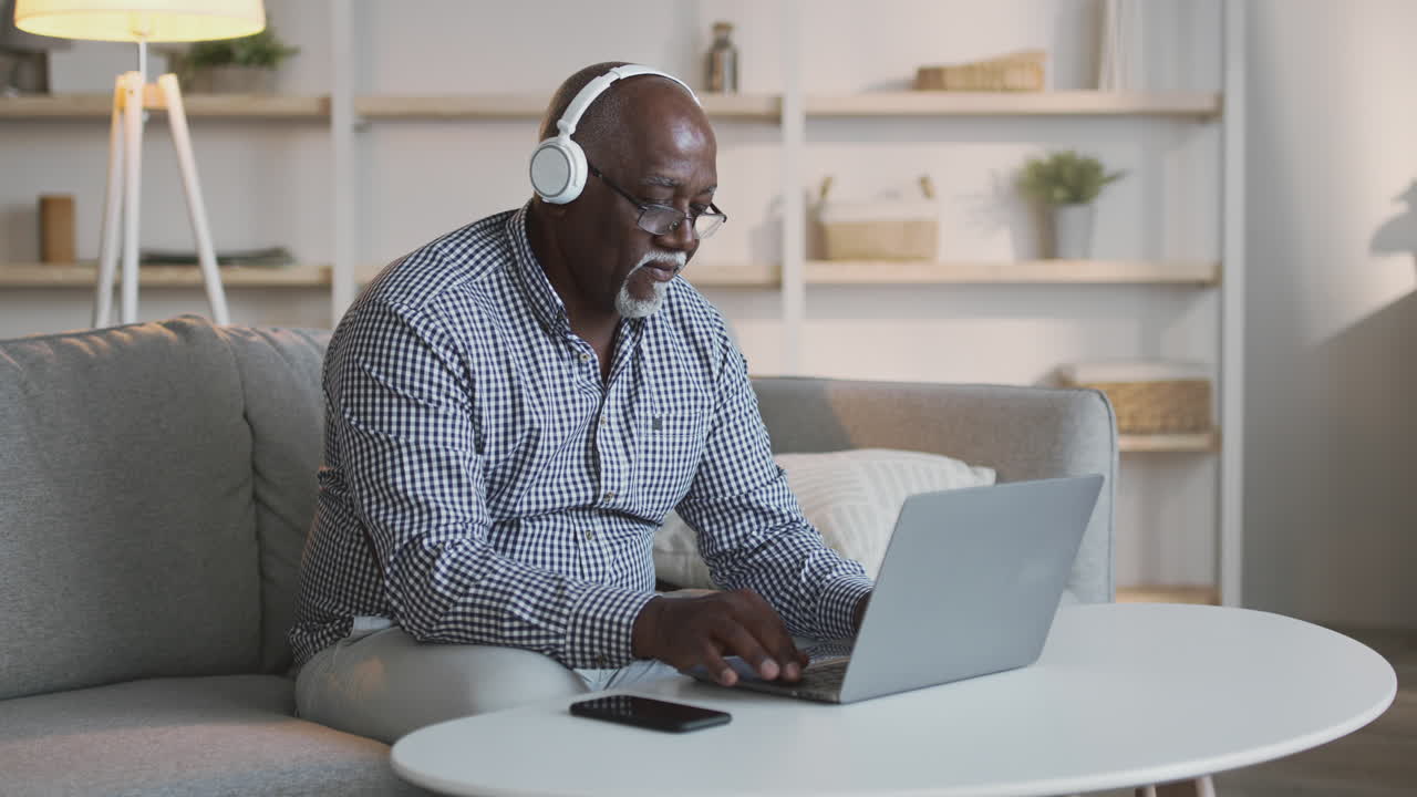 Senior Man Working on Laptop at Home