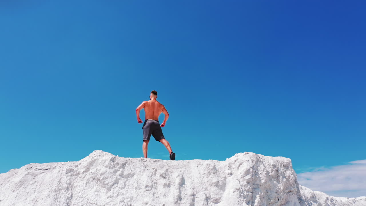 Professional bodybuilder posing. Concept of sport outdoors. Aerial view.