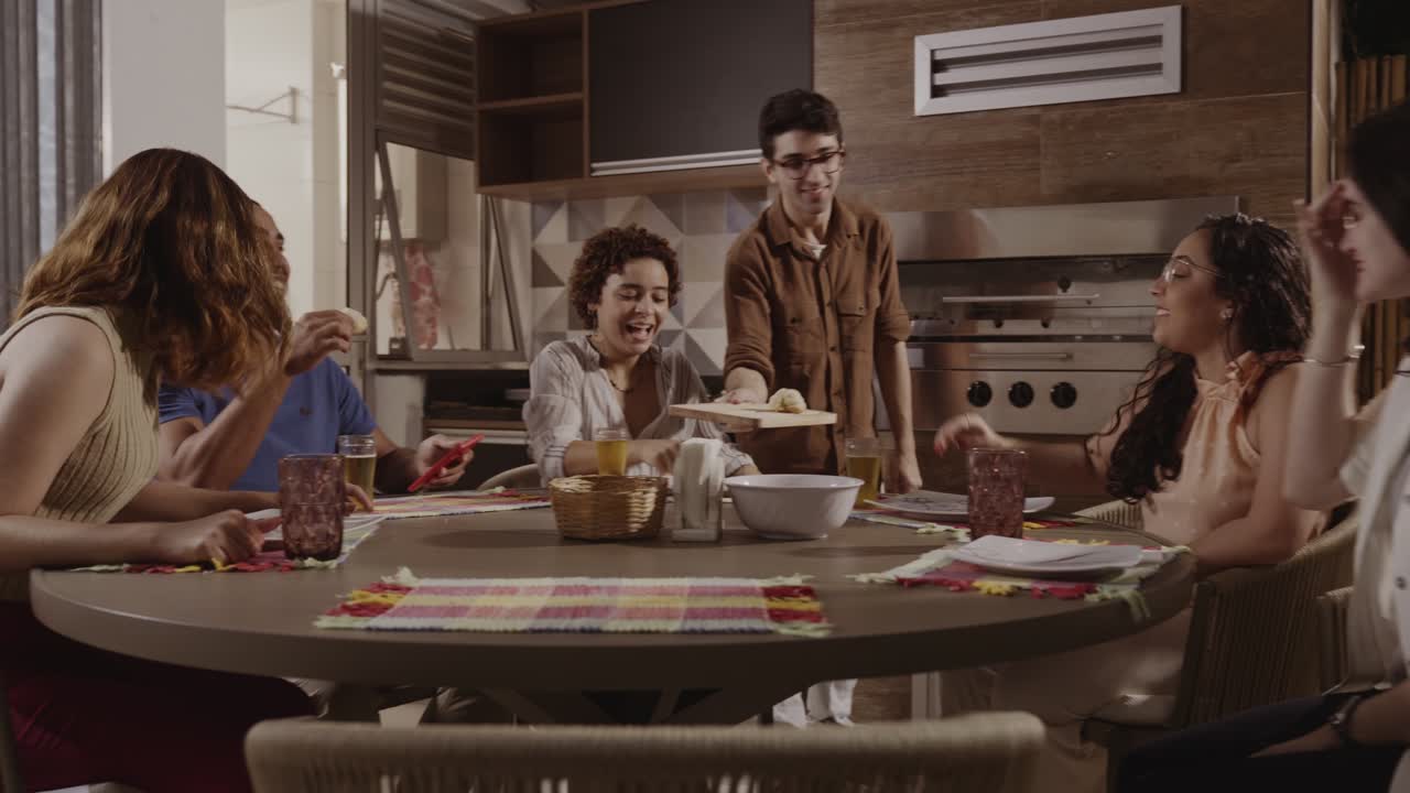 Friends and family gathered around a table, sharing food and laughter