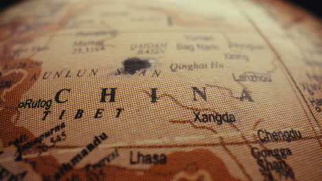 close-up of a globe focusing on china and tibet