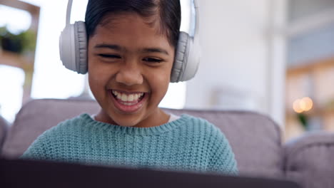 Girl-kid,-laptop-and-headphones-on-sofa