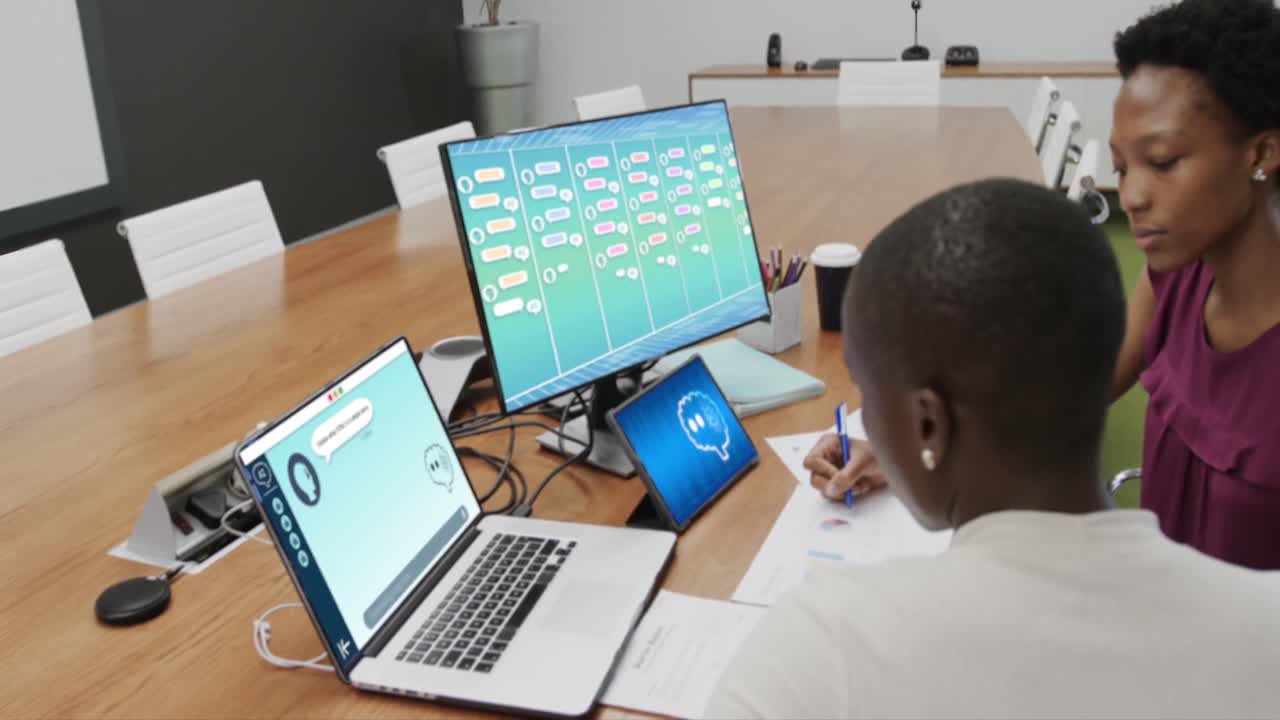 African american businesswomen talking and using technology with digital chat and media icons