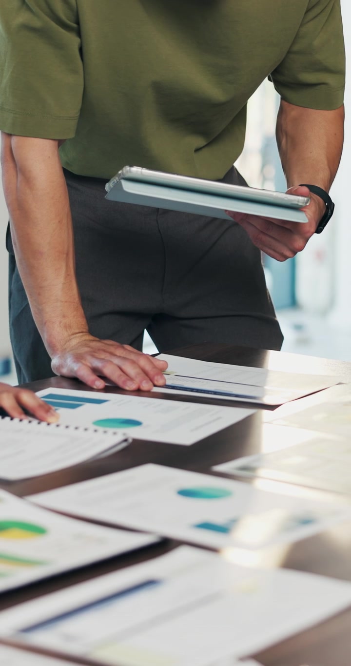 Business Professionals Reviewing Financial Charts in Office Meeting