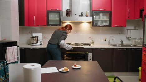 in the red domestic kitchen a woman bakes cookies