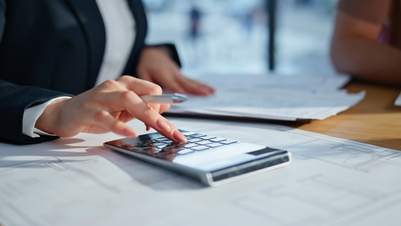 Businesswoman hands analyzing financial report at desk with colleague closeup