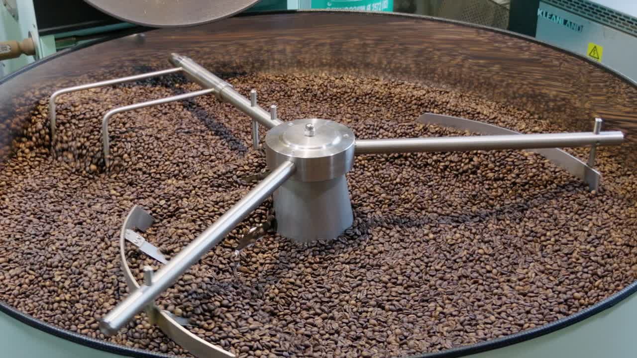 Discover the intricate process of coffee roasting showcasing rich textures and vibrant colors.