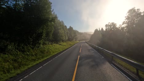 fog on a norway road. pov car trip. vehicle point-of-view driving a car on a road in norway.