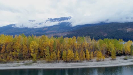 autumn forest and mountain ranges along the lake 4k