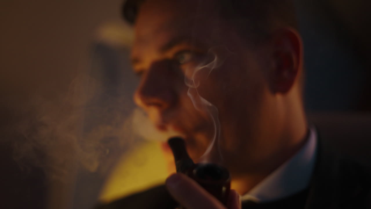 Man Lighting and Smoking Pipe