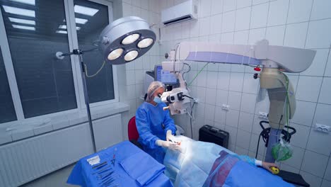 laser correction for vision. surgeon hands in gloves performing laser eye vision correction