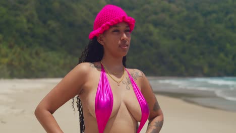 in trinidad, a girl in a thong bikini enjoys a beautiful day on a caribbean beach