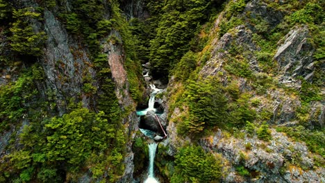 New-Zealand-Drone-Aerial-of-Devil’s-Punchbowl-Waterfall,-Flying-Away-from-Falls