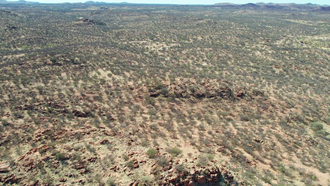 Drone view of the dry rocky landscape north of Alice Springs, Mparntwe. Northern Territory, Australia. August 2022.