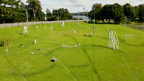 aerial flyover green grass field with weather station, wireless measuring station in poland