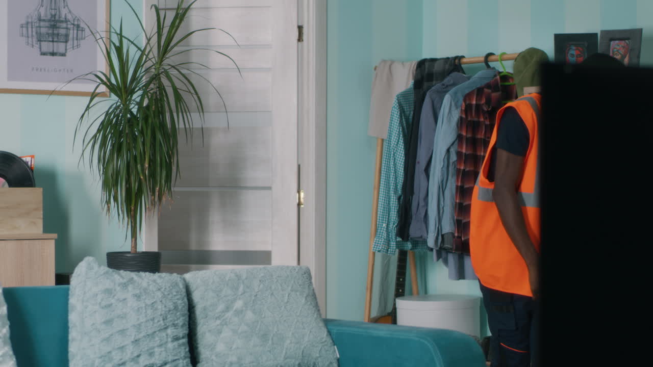 Tired Black Builder Falling on Sofa