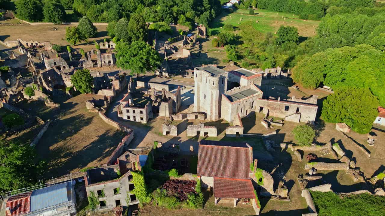 Drone view of medieval buildings at Village martyr d'Oradour-sur-Glane and ruins with central destroyed church, Haute-Vienne, France