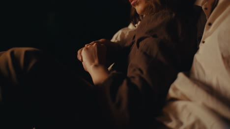 couple holding hands in dim light