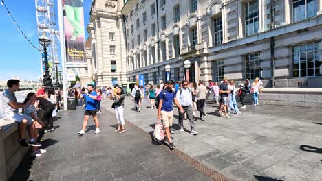 crowds walking on a sunny day in london