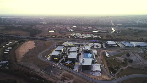 Smooth-aerial-decent-over-newly-developed-shared-working-facility-beside-main-toll-way