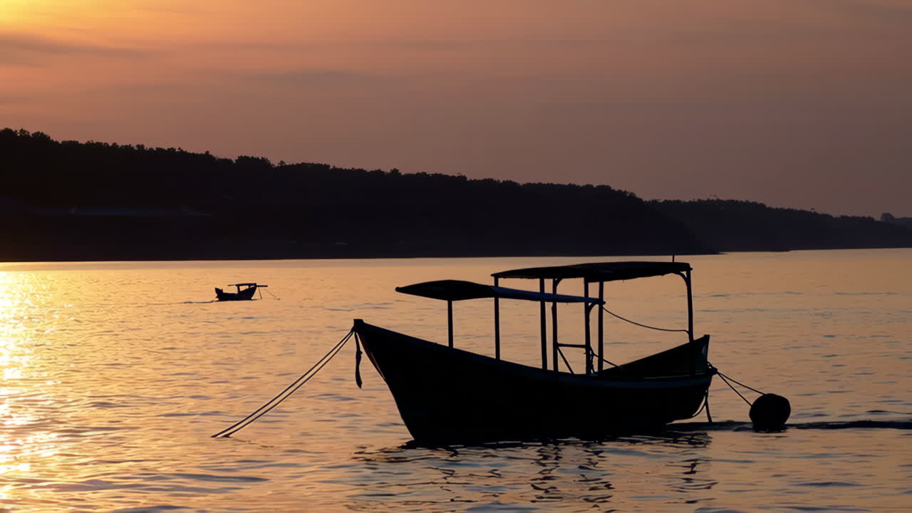 Silhouette of boats at sunrise/sunset over a calm river