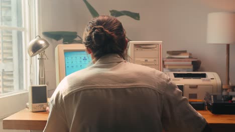 man working and gaming on retro computer pc, it engineer with vintage computer at home, using old fashion technology, close up of retro setup.