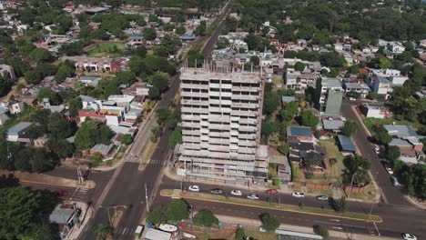 Bird's-eye-drone-footage-provides-a-compelling-view-of-a-building-under-construction-and-its-surrounding-urban-environment