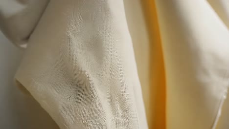 close up of a white fabric with a yellow detail