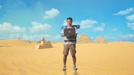 full body of asian male hiker with mountaineering backpack looking at a laptop and saying wow while traveling in pyramid of giza