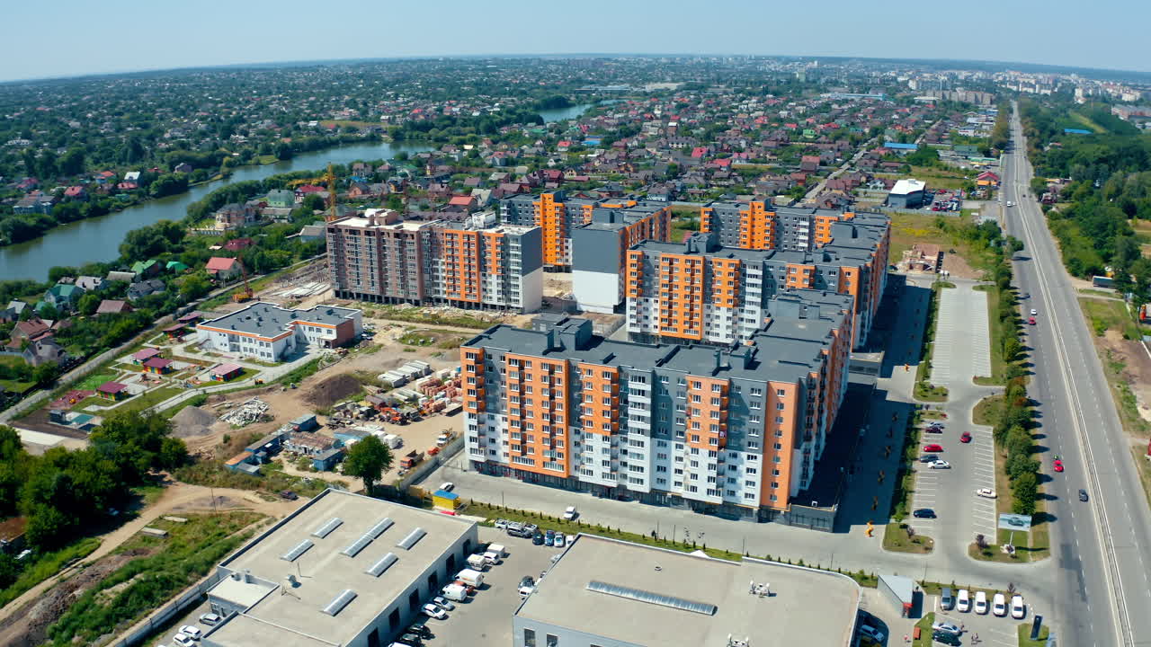 Beautiful residential complex. Modern infrastructure in the outskirts of a city. Construction of bright high-rise buildings of a new district. Aerial view.