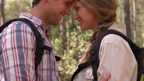 smiling couple on a hike hugging