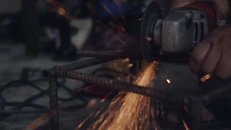 worker man using electric wheel grinding and cutting on steel structure