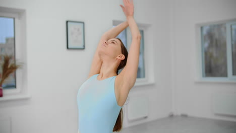woman practicing yoga or stretching in a bright studio