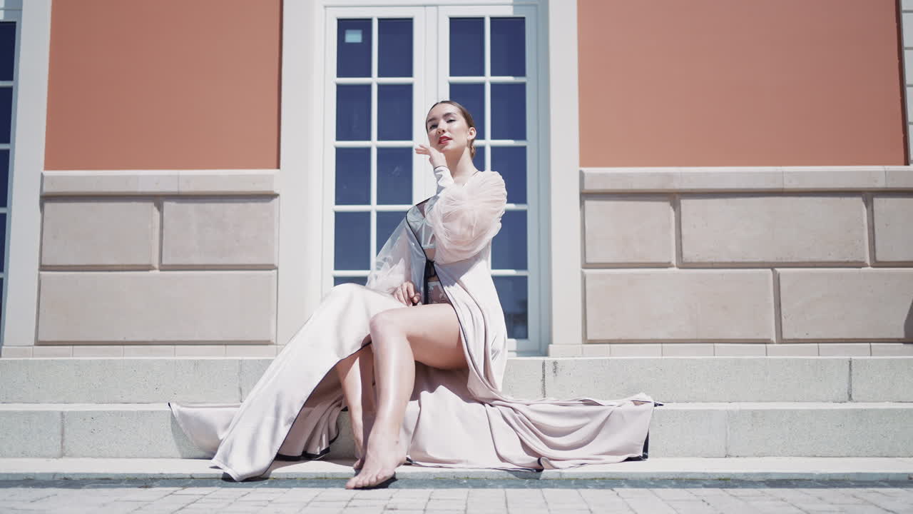 Elegant Woman in a Light Beige Dress on Steps
