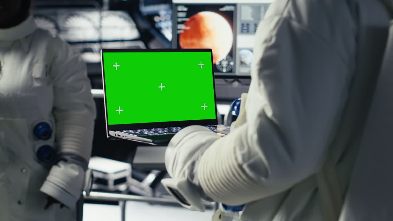 Astronaut monitoring system on isolated screen laptop, chatting with colleague