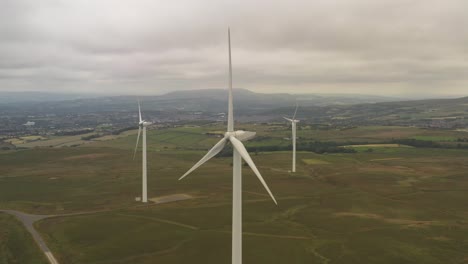 drone footage of a group of wind turbines on farmland