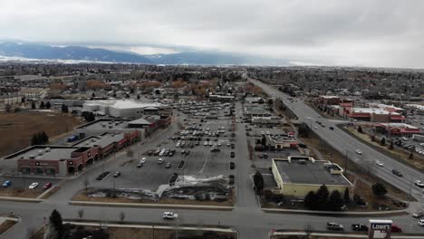 drone shot above parking lots and stores in a commercial area