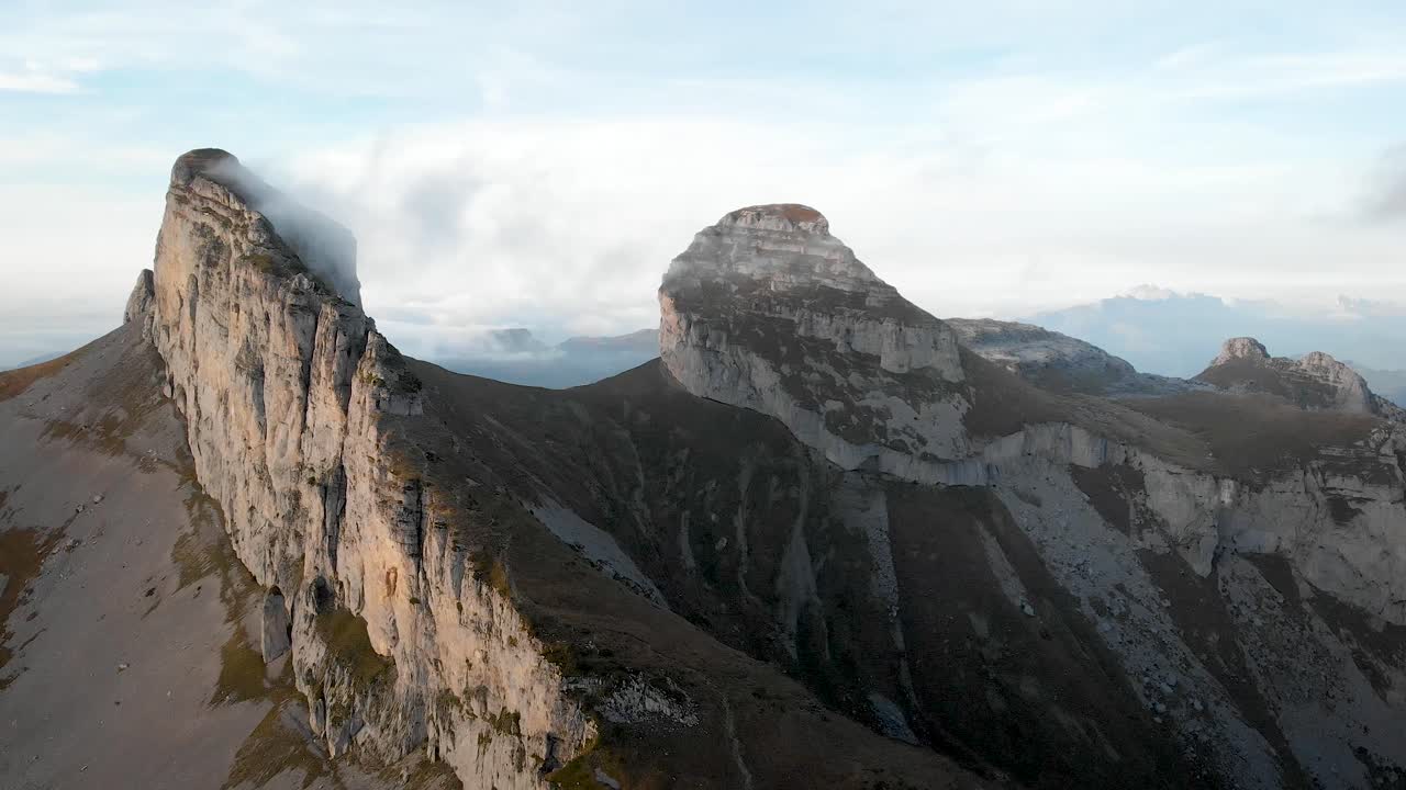 Aerial flyover with a view of Tour d'Aï and Tour de Mayen in Leysin, Vaud, Switzerland during a colorful autumn afternoon in the Swiss Alps