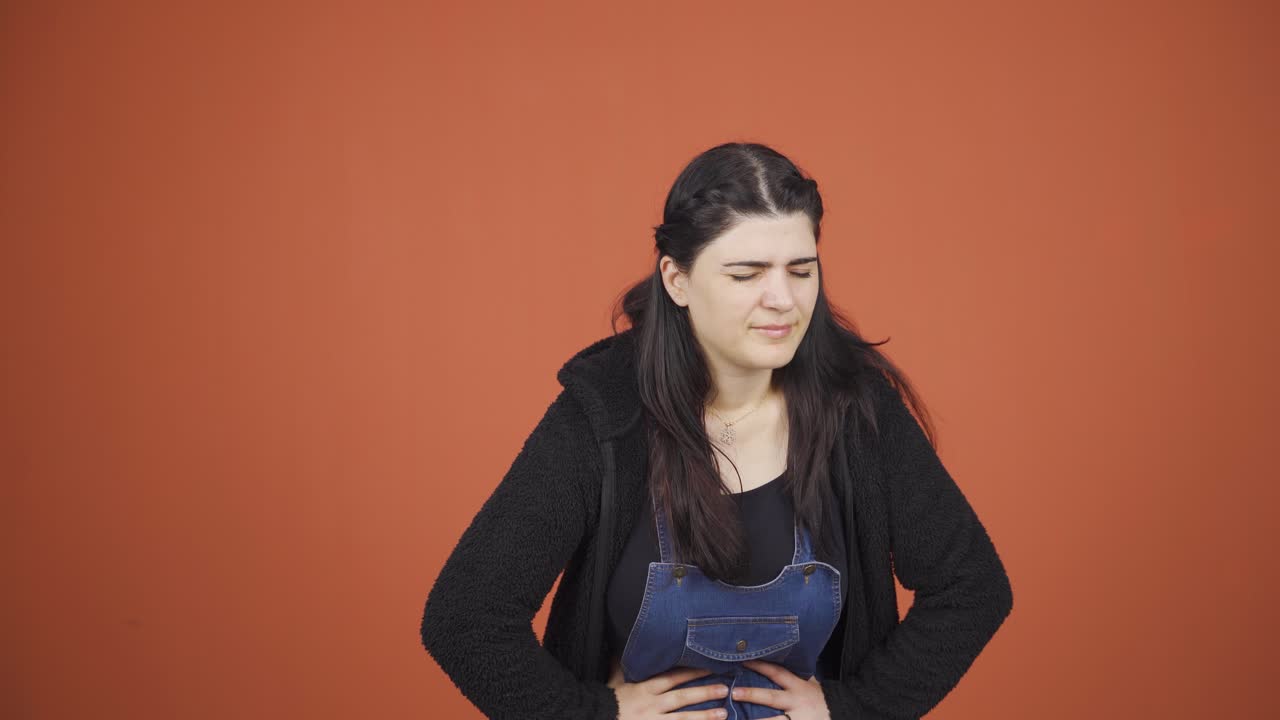 Woman experiencing stomachache.