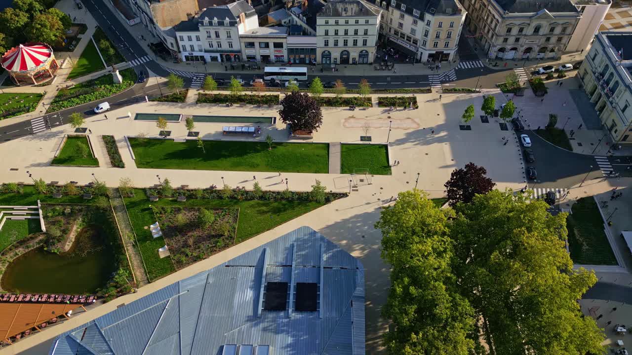 Aerial pullback ascend of Laval city center with river bridge, chateau, and Notre Dame Avesniere visible, urban greenspace