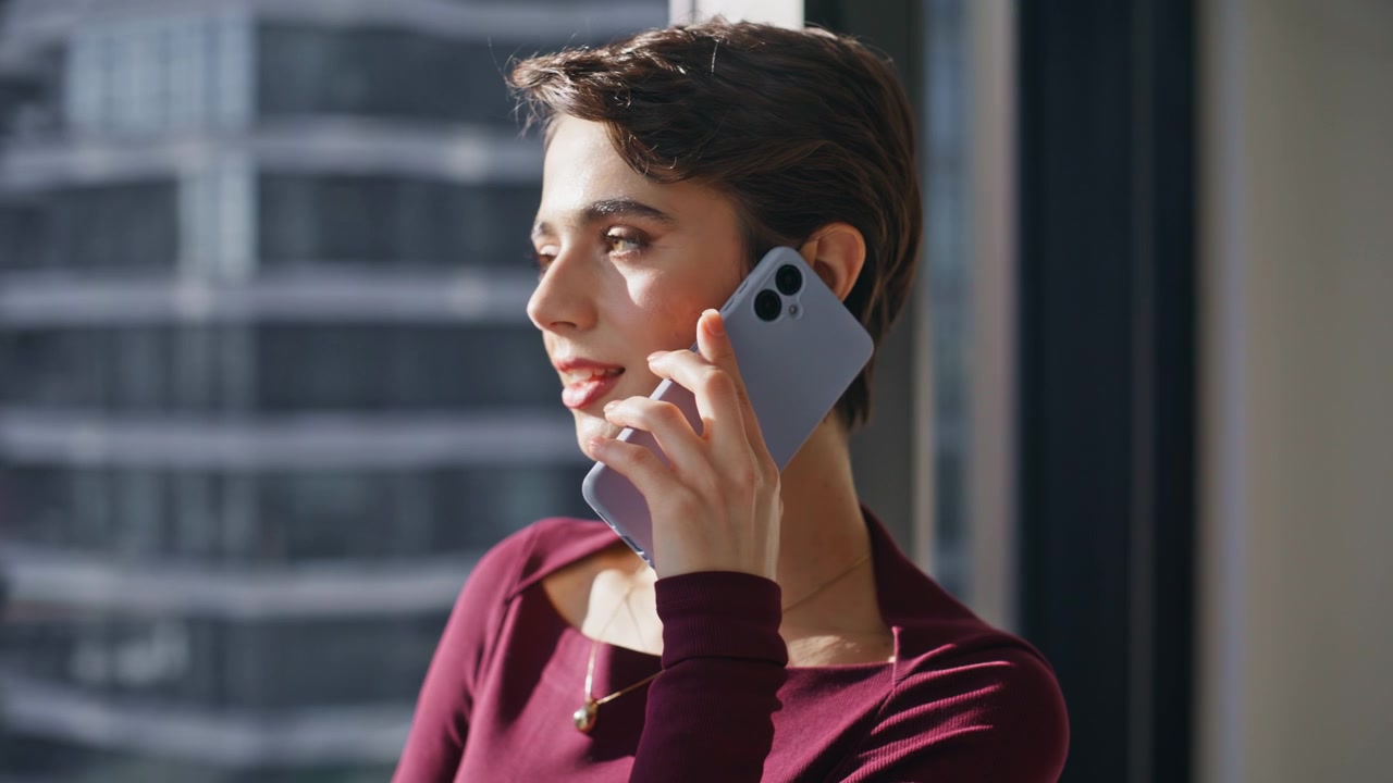 Smiling business woman talking smartphone office window. Closeup model posing