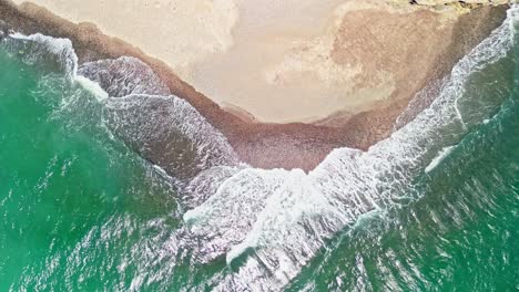 aerial top down shot of waves reaching the shore at tortuga island, costa rica