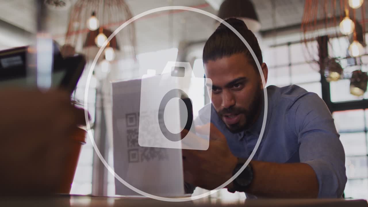 Animation of camera icon and data processing over biracial businessman in office