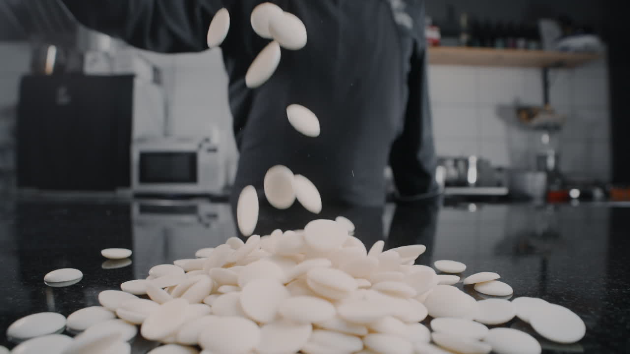 Chef pouring white chocolate