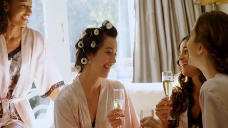 four happy bridesmaids in nightdress having a glass of champagne 4k 4k