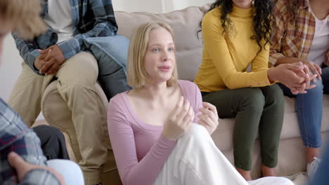 Thoughtful-diverse-group-of-teenage-friends-at-meeting-talking-at-home,-slow-motion