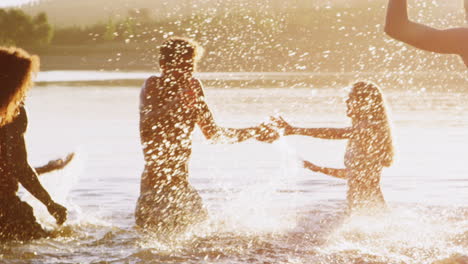 Adult-friends-having-fun-in-a-lake,-close-up-panning-shot